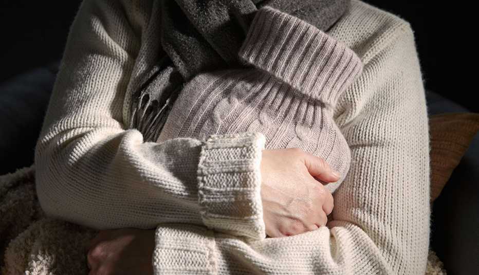 a woman holding a hot bottle to warm up