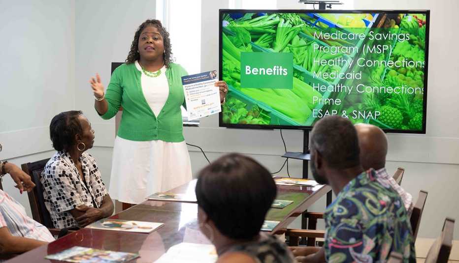 Stephanie McGuire standing table Stephanie McGuire works at SC Thrive, an AARP Foundation grantee based in Columbia, South Carolina, and helps guide people through the complicated application processes for SNAP benefits (formerly food stamps) and Medicare Savings Programs (MSP).