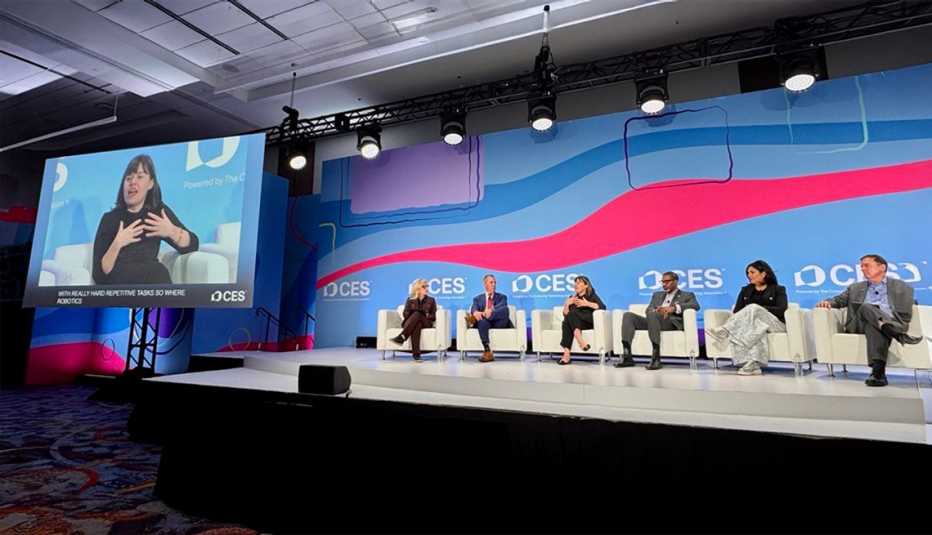 Claire at CES with panel of speakers