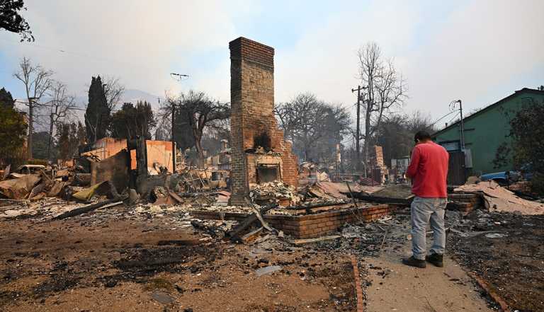 LOS ANGELES, CALIFORNIA - JANUARY 9: Residents inspect the area among the rubbles of their burnt houses during Eaton wildfire in Altadena of Los Angeles County, California, United States on January 9, 2025. A fast-moving wildfire has forced 180,000 people to evacuate, with officials warning that worsening winds could further escalate the blaze. (Photo by Tayfun Coskun/Anadolu via Getty Images)