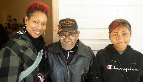 Frederick Lonzo poses with daughter Leah and granddaughter Tehlyr outside his rebuilt home.