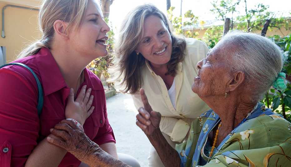 Debra Whitman, AARP Foundation President Lisa Ryerson, Mirta Pierre, 90, St. Vincent de Paul nursing home, Leogane, Haiti