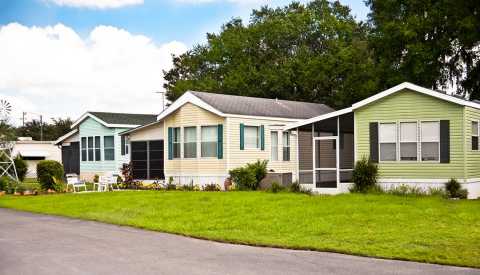 Mobile homes in a manufactured home park. Front yard.