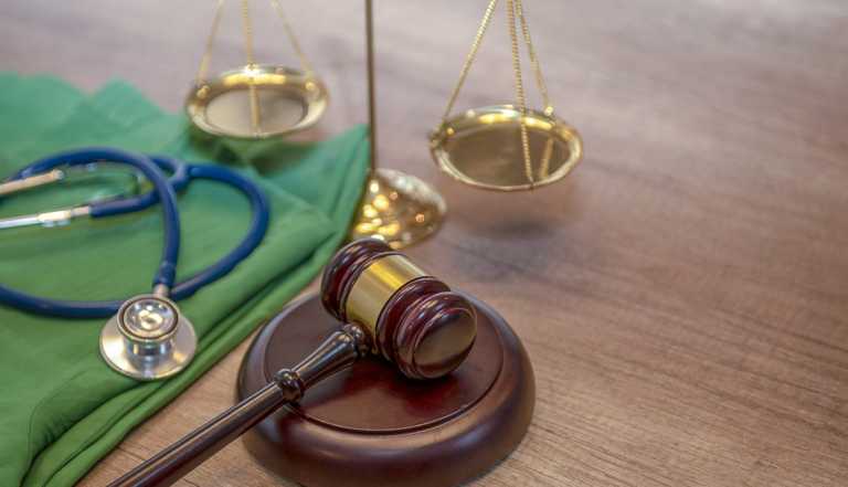 Medical law concept, Gavel and stethoscope in background.