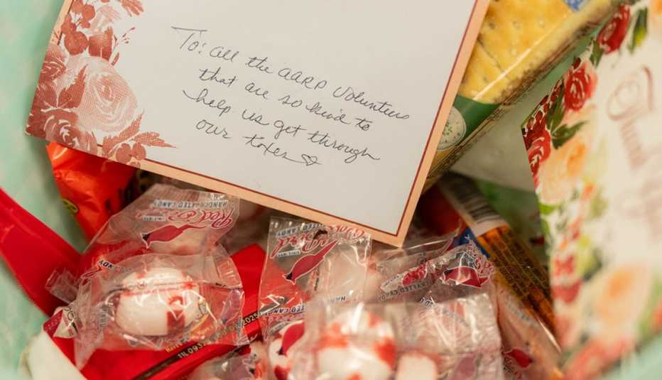 “Thank you” basket of goodies of candies and hand-written card on a table from an anonymous client.