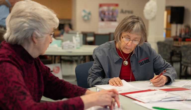 Marylou Murray, Tax Aide volunteer works with a client at AARP Foundation Tax Aide service in Culpeper, Virginia on March 13, 2025.