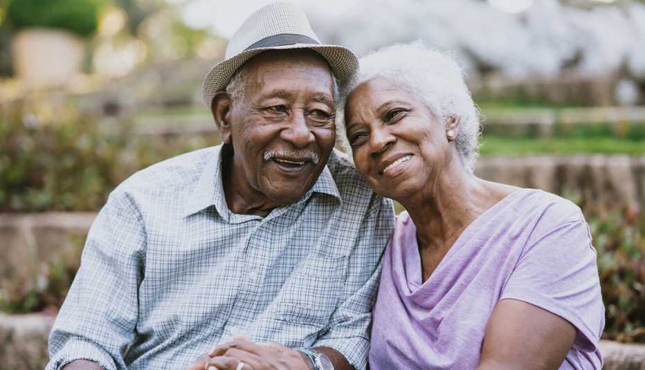 African American Older Husband and Wife Sitting Outside at a Park