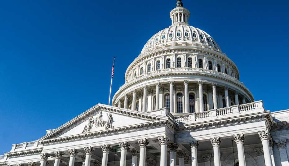 The dome of the United State Capitol against a deep blue sky in Washington, DC.