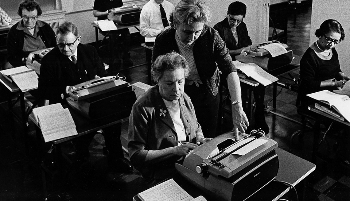 People typing in a classroom