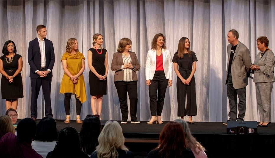 A A R P C E O Jo Ann Jenkins on stage congratulating a group of finalists during the staff pitch event 