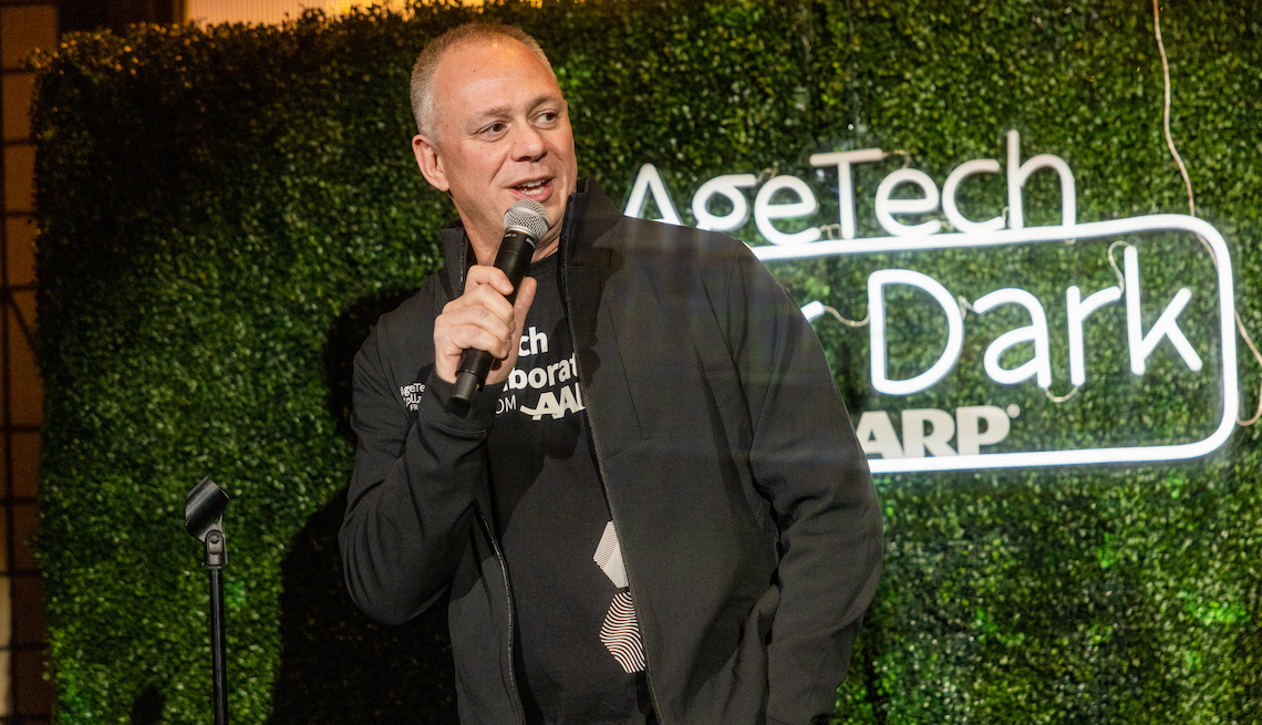 andy miller talks into a microphone at the agetech after dark event
