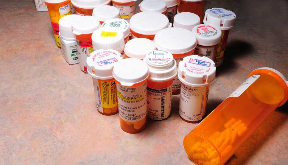 Prescription bottles and pills on a counter