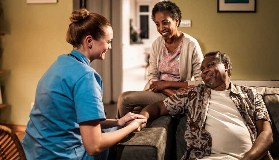 Close up of a female nurse doing a check up on her patient at his home