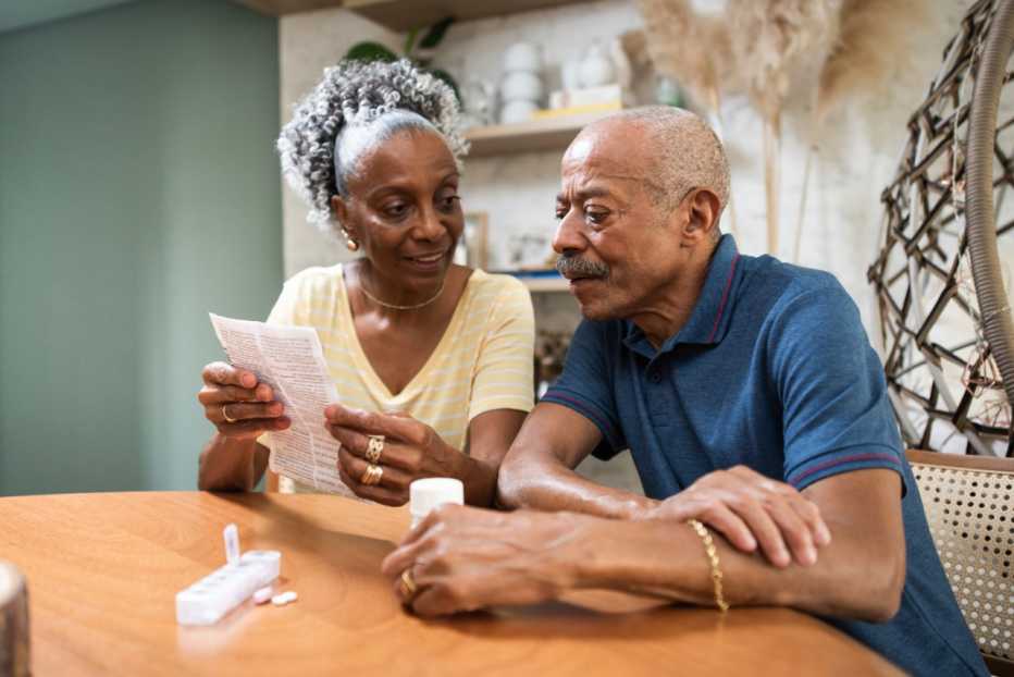 Senior African American couple reviewing prescriptions