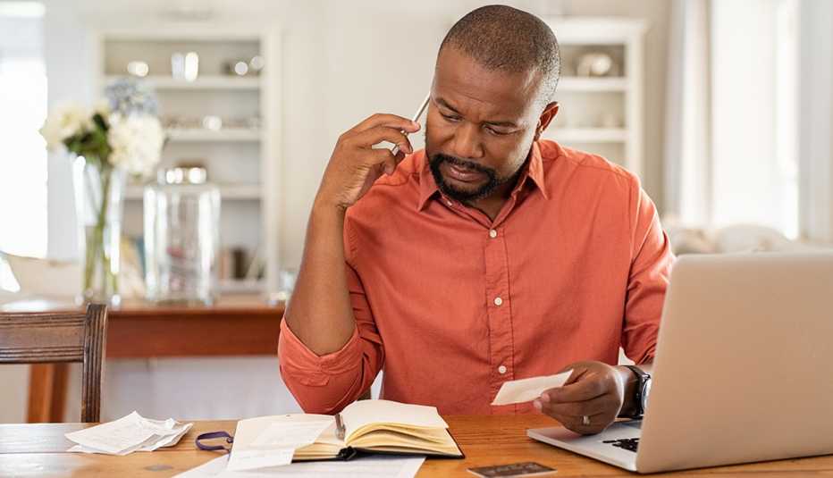 A man is looking at paper work on his desk