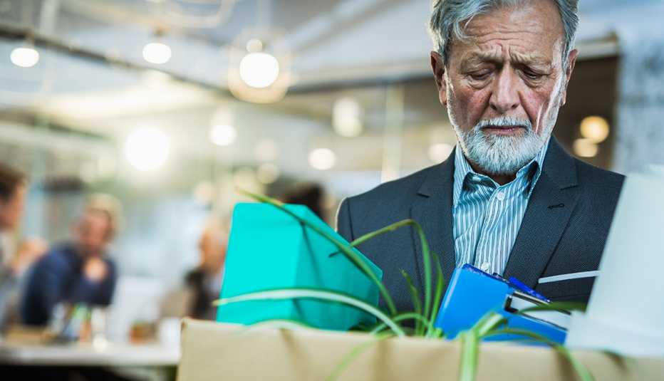 Older man leaving his office