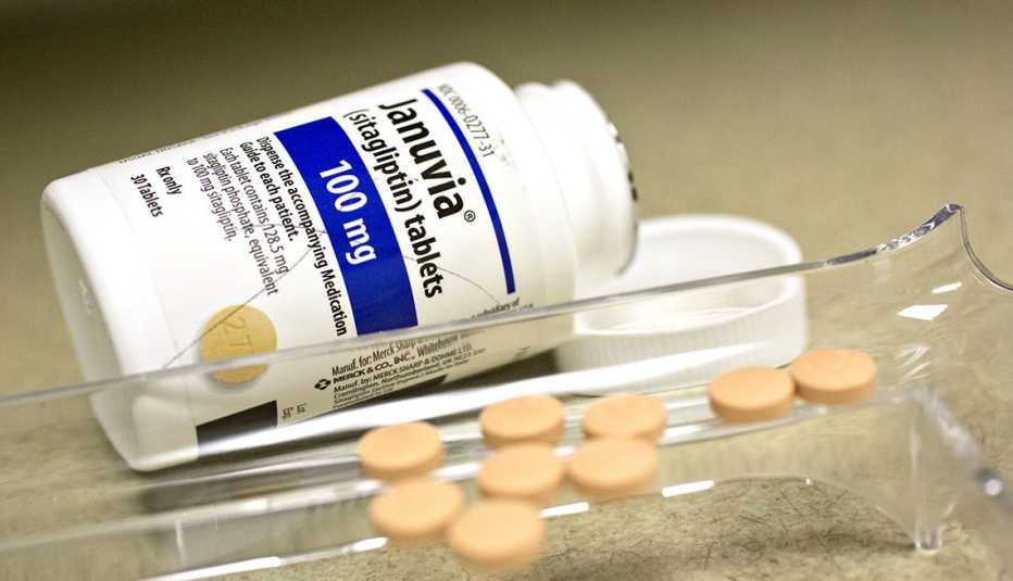 a white bottle of januvia with pills sitting next to it