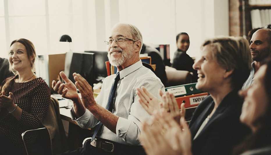 A meeting with workers clapping their hands