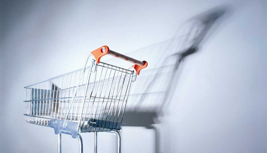 empty shopping cart casting long shadows on a wall