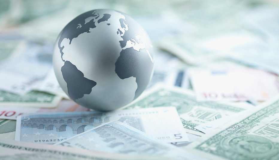 a globe on top of paper money