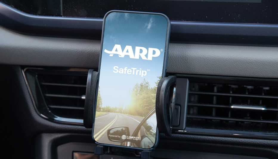 phone mounted on car dash showing a a r p safe trip app