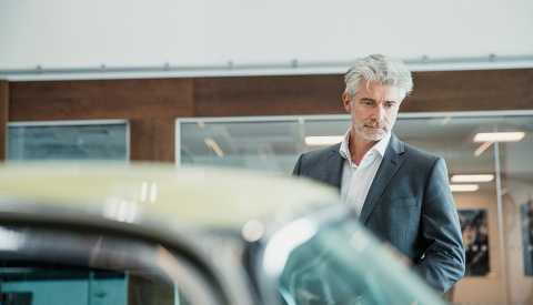 customer looking at a car in the foreground