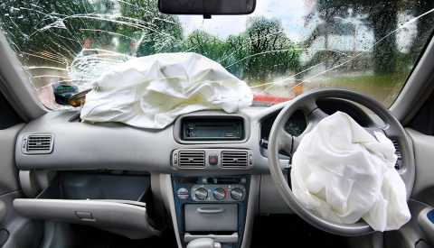 car airbags on a dashboard with a cracked windshield car airbags on a dashboard with a cracked windshield