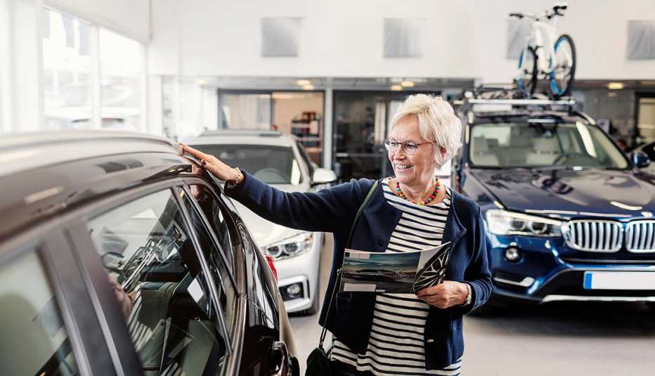 woman looking at car in showroom