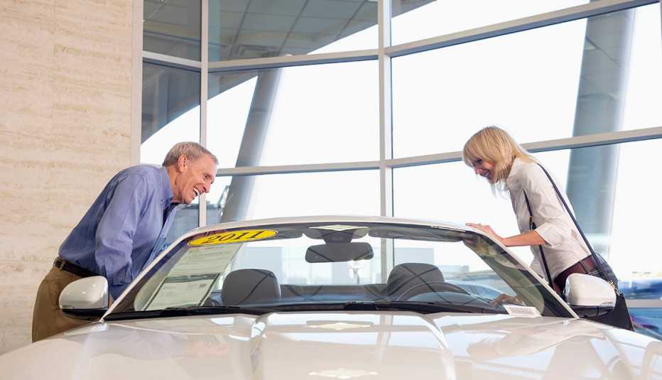 couple admiring car in dealership