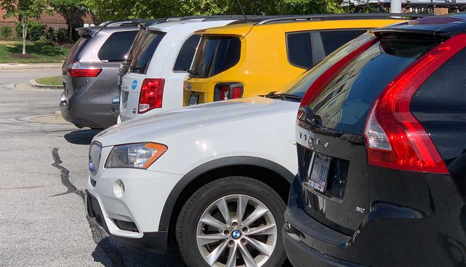 assortment of various cars in a parking lot
