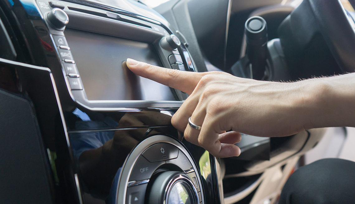 Woman using touch screen in car