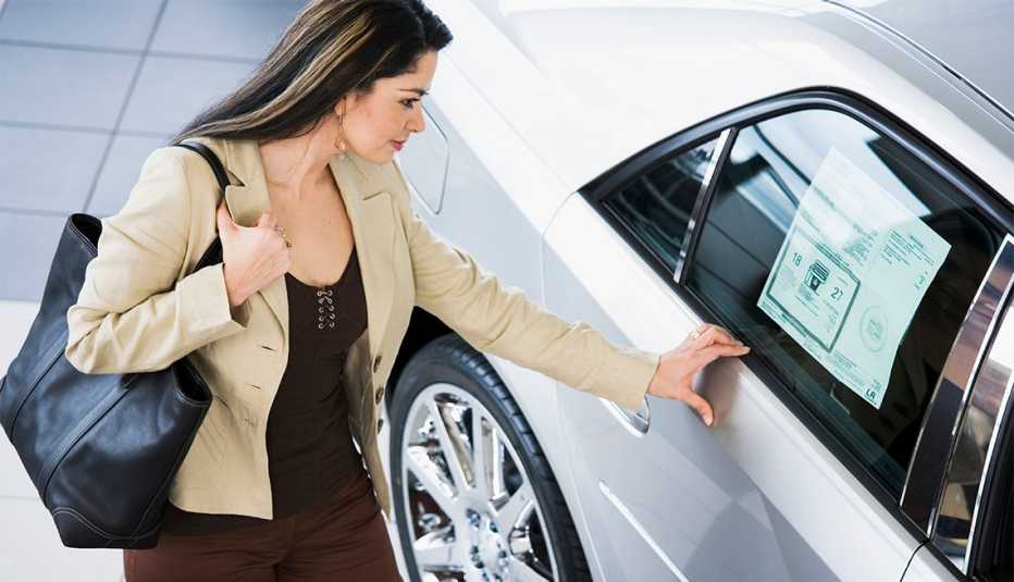 woman looking at a new or used vehicle