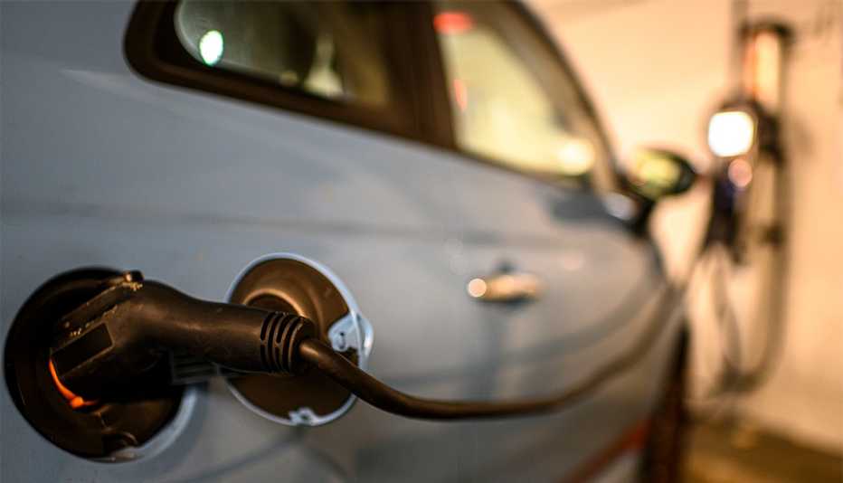 Electric car plugged into a charging station while parked.