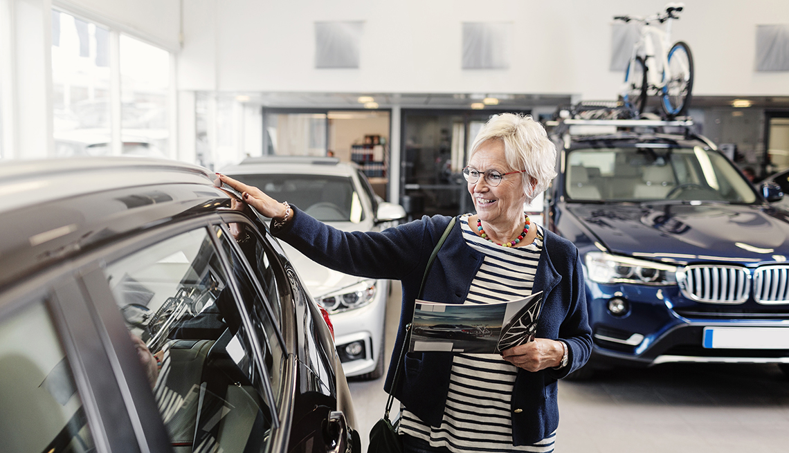 woman looking at car in showroom
