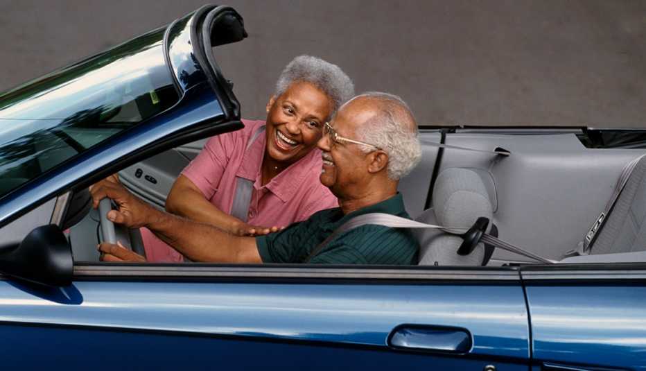 a man and woman drive in a car