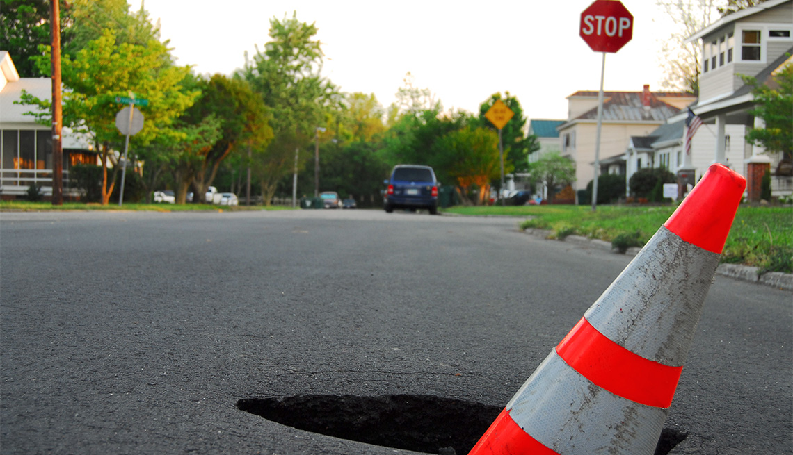 pothole in the middle of a street 