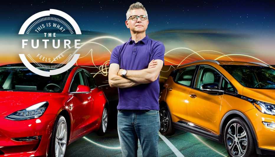 jim leaham standing next to two electric cars