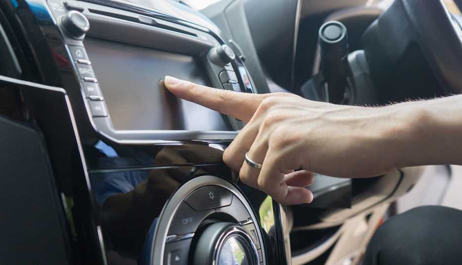 Woman using touch screen in car