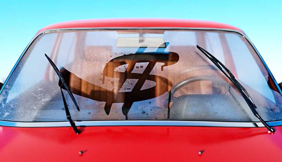 a dollar sign wiped into a fogged up automobile windshield to signify high costs and expenses