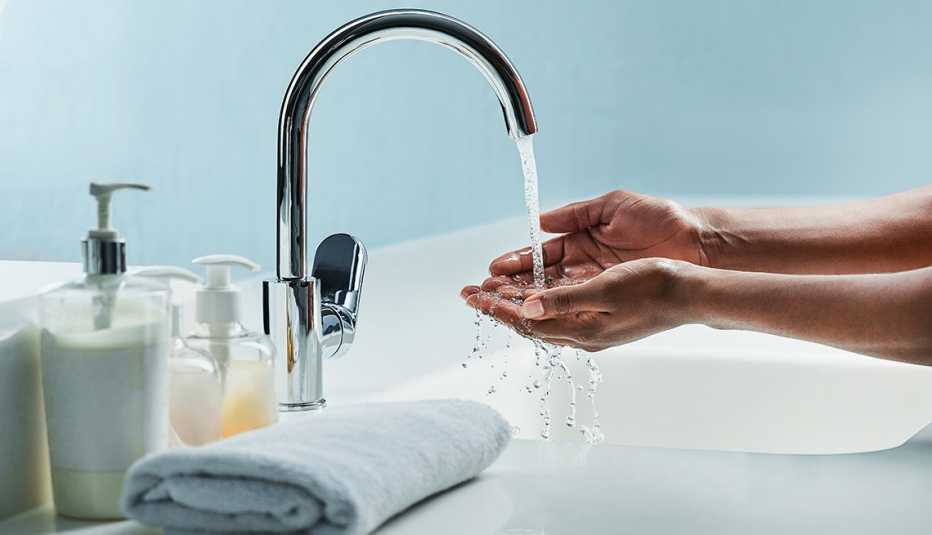 man washing his hands in a bathroom sink