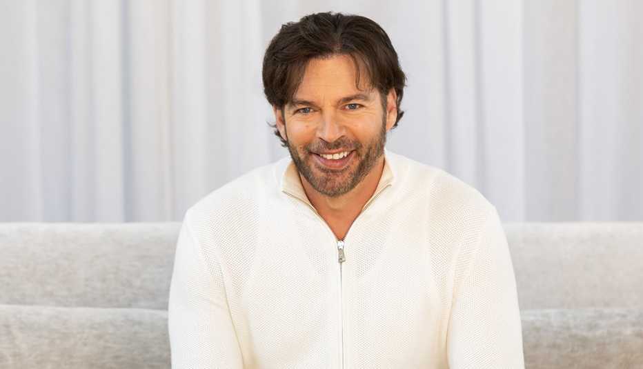 harry connick junior sitting on white couch against white background