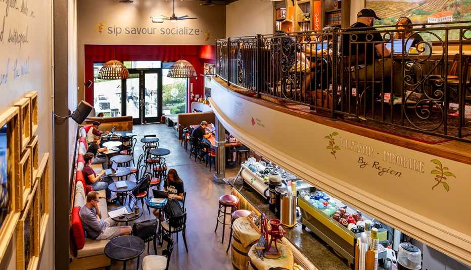 inside a coffee shop that&rsquo;s two levels; people sitting at tables