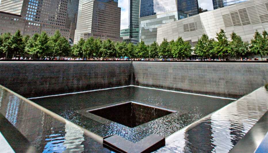 Large square memorial with people gathered around it