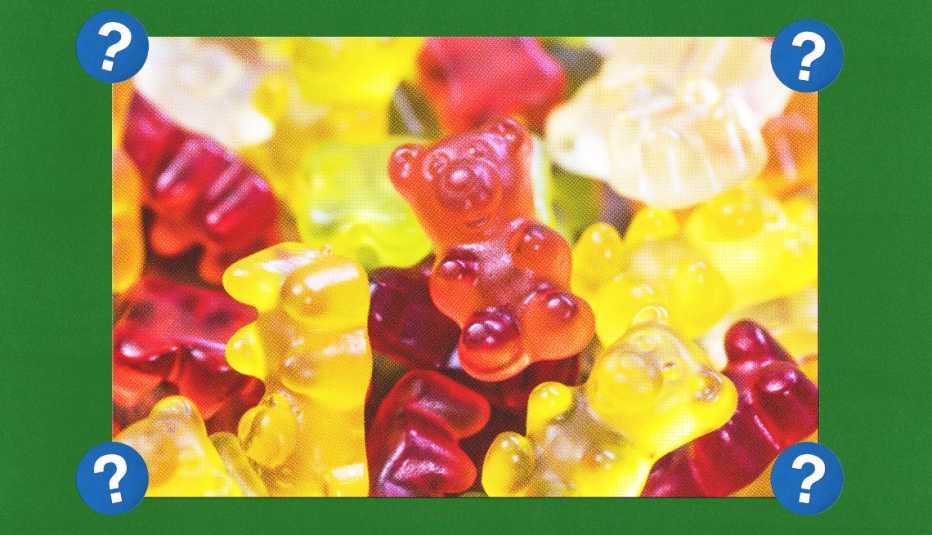 Yellow, orange, red and clear gummy bears; surrounded by blue circles with question marks in them