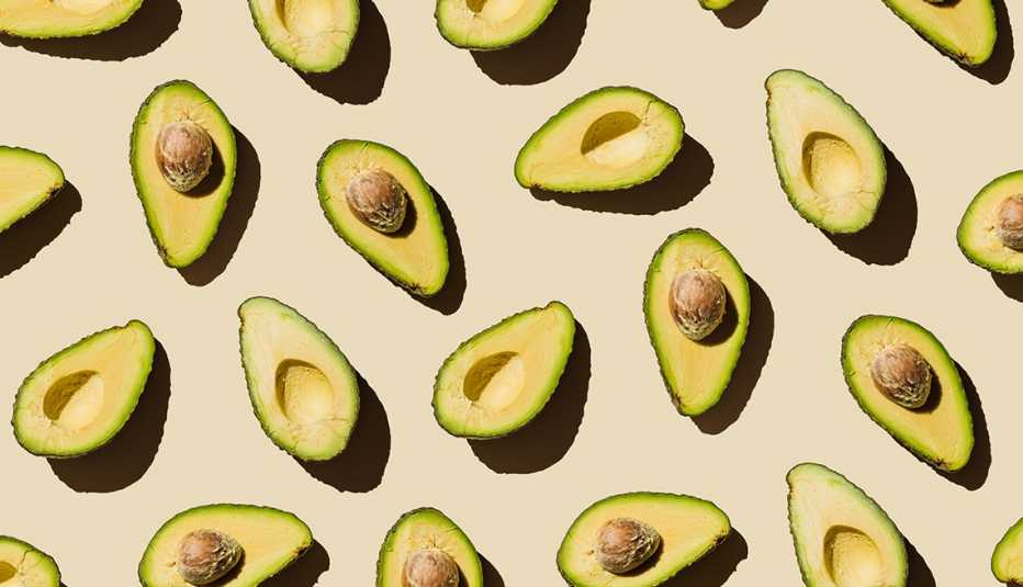 a bunch of avocado halves facing up
