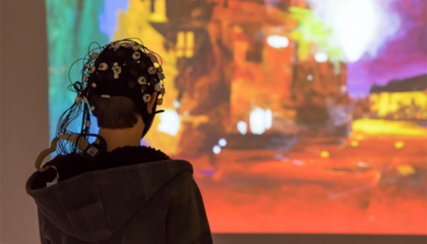 Electrodes connected to the head of a person looking at art