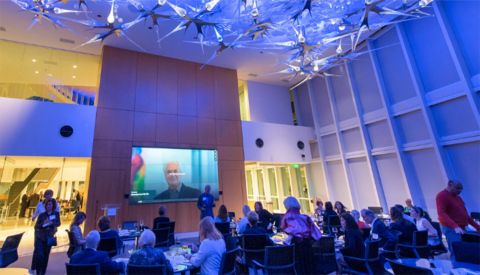 Dr. David Yeager at a speaking engagement in front of an audience sitting at tables
