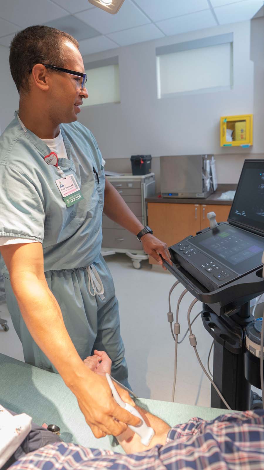 Doctor performing an ultrasound scan on a patient during a medical examination in a healthcare facility