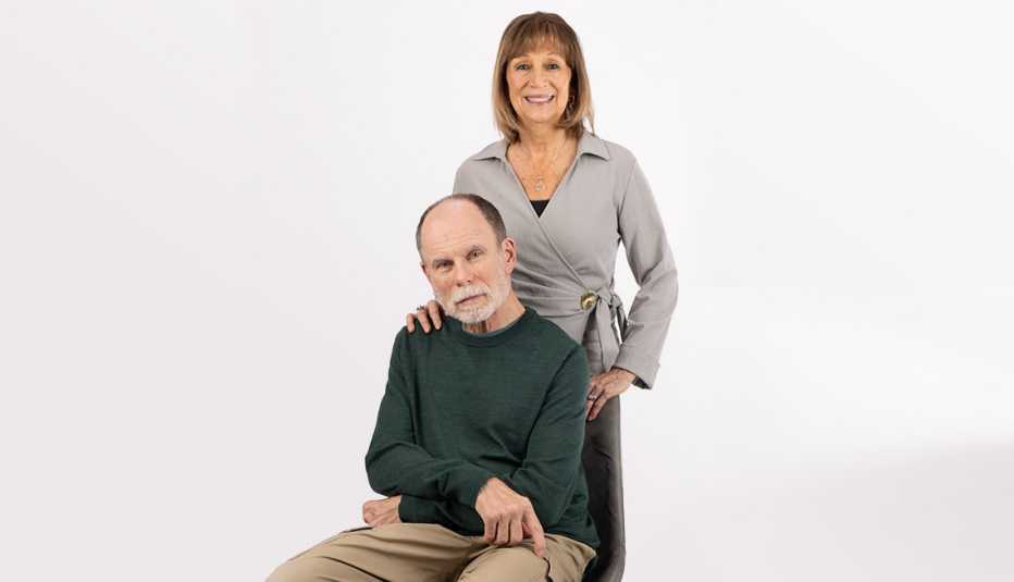 A man sitting in a chair and a woman standing behind him