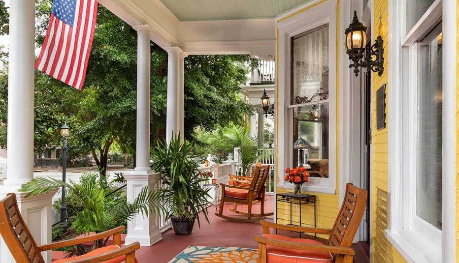 Home front porch with chairs and American flag